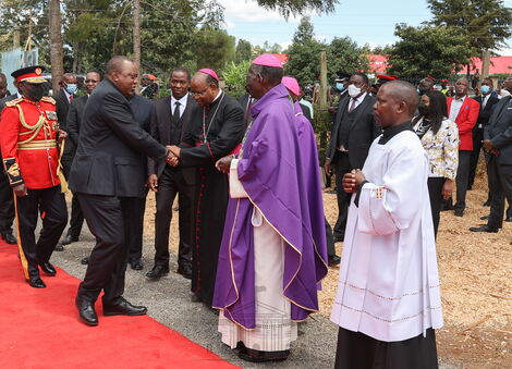 President Uhuru Kenyatta shaking hands with Nyeri Catholic Archbishop, Anthony Muheria in Othaya on April 30, 2022.