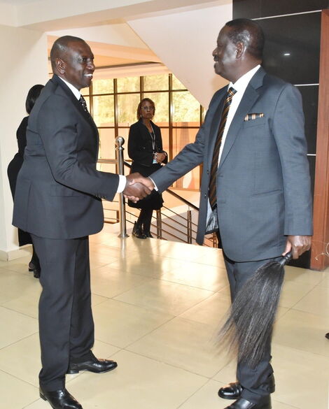 Deputy President William Ruto shakes hands with former Prime Minister Raila Odinga at President Mwai Kibaki's State Funeral at Nyayo stadium on April 29, 2022.