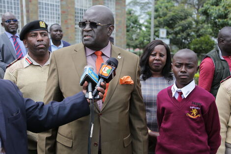 Education CS George Magoha addresses the media alongside Kapsabet High student, Fred Ekiru on May 7, 2022. 