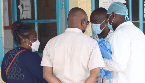 Family and friends of doctor James Gakara consult at the Nakuru level five hospital
