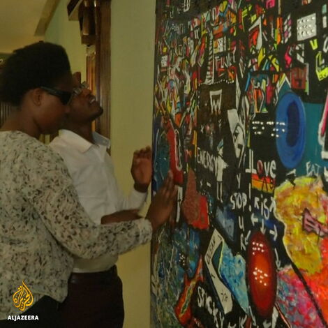 Fans interact with Tina Benawra's art.