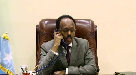 Somalia President Abdullahi Farmajo on a phonecall in his office in March 2020