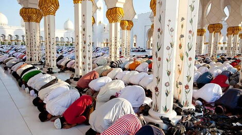 Followers of the Muslim faith worshipping inside a mosque.