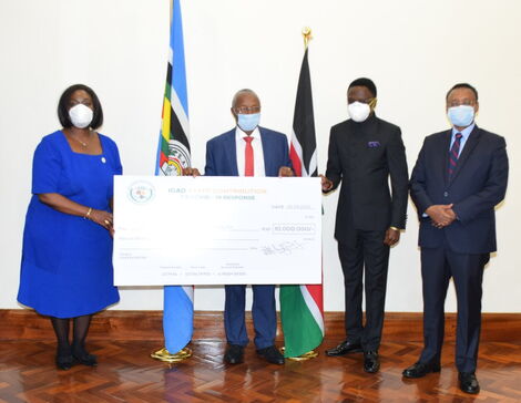 Foreign Affairs Cabinet Secretary Raychelle Omamo (Left) receiving a cheque of Ksh10 Million rom IGAD staff, towards the COVID-19 Emergency Respond