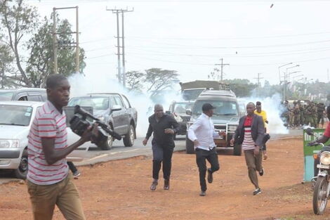 Former Kakamega Senator Boni Khalwale (in black cap) runs from Anti-Riot police officers who stormed a parallel meeting during a rally in Mumias on January 18, 2020.