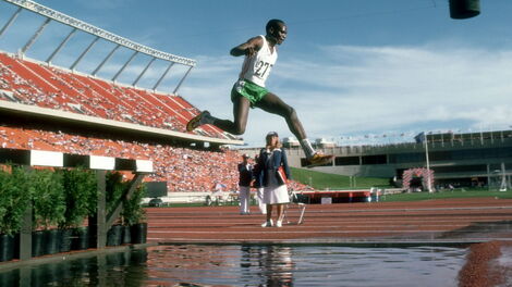 Former Kenyan athlete Henry Rono participates in a steeplechase.
