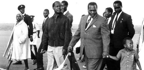 Former President Mzee Jomo Kenyatta (centre) with a young Uhuru Kenyatta, Vice President Moi (behind him) and former Attorney General Charles Njonjo (to Mzee Jomo's right) in the mid 1960s..jpg