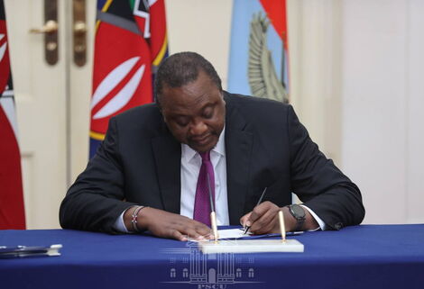 Former President Uhuru Kenyatta signs the Military Veterans Bill into Law in June 2022.