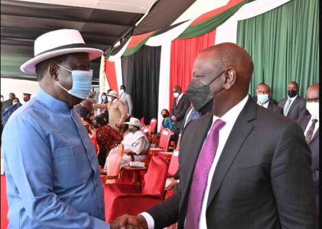Former Prime Minister Raila Odinga (left) greets Deputy President William Ruto during the Jamhuri Day celebrations on Sunday, December 12, 2021.
