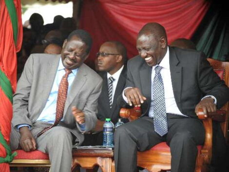 Former Prime Minister Raila Odinga and Deputy President William Ruto laughing at an event in October 2017.
