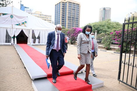 Fred Ngatia being escorted by the Secretary to the JSC Anne Amadi, at the close of his 5-hour interview session on April 20, 2021
