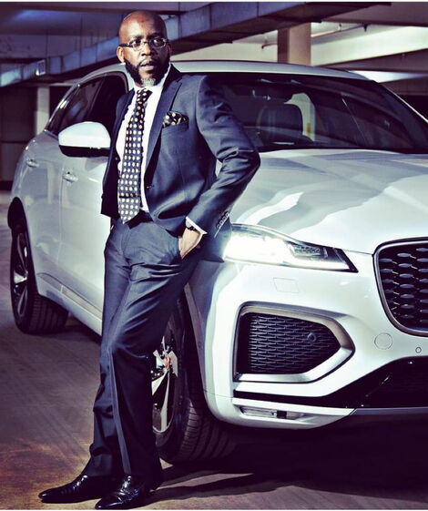 File Photo of Jimmy Gathu posing for a photo leaning on a car