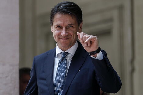 Italian Prime Minister Giuseppe Conte waves.