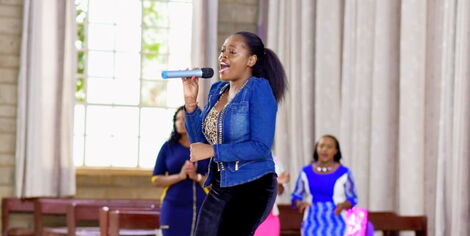Gospel musician Betty Bayo performing in Church.