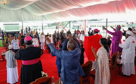 Dignitaries and other invited guests raise their hands in gesture of worship during the prayer rally held at State House Nairobi on March 21, 2020.