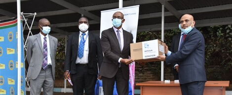 Health CAS Rashid Aman (Second from Right) receiving the medical donation from a Fosun Pharma representative outside Afya House on August 25, 2020.