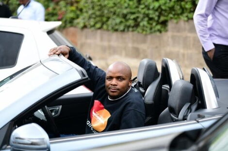 Media personality Jalang'o inside his convertible Mercedes Benz