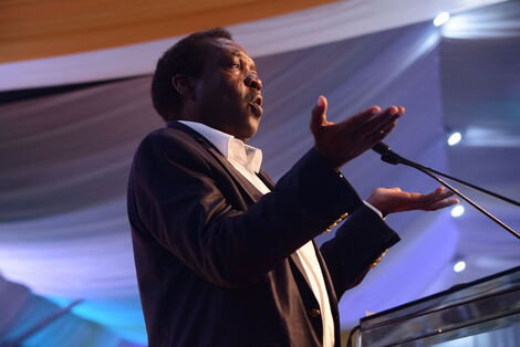 Political analyst Herman Manyora gestures while delivering an address at a past event