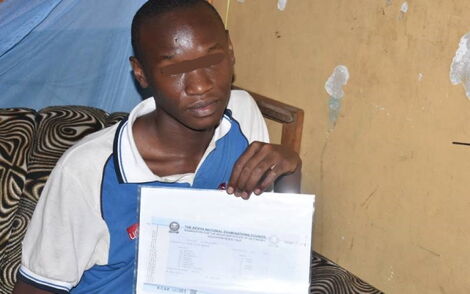 Kevin Otieno Displays His KCSE Result Slip