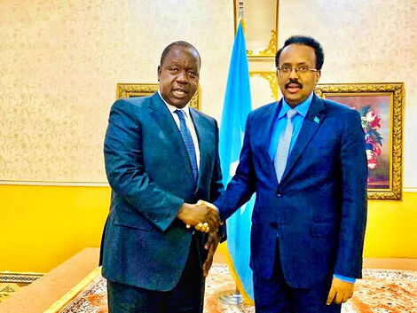 Interior CS Fred Matiang'i greets Somali President Mohammed Farmajo after their meeting in Somalia on Sunday, March 8, 2020.