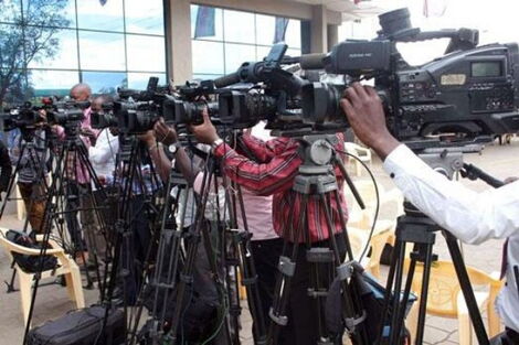 Journalists docked at a media center while covering an event.