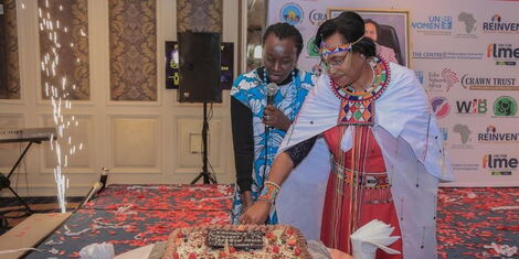Professor Kobia cutting cake during the event on Wednesday, November 30, 2022.