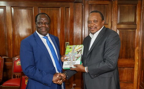 Kakamega Governor Wycliffe Oparanya (l) hands President Uhuru Kenyatta the Sugarcane Taskforce Report on February 24 at State House Nairobi..jpg