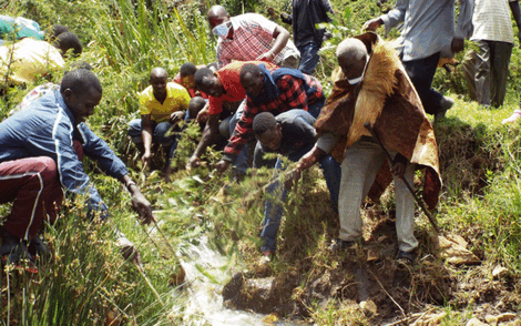 Kalenjin elder Leonard Kirwa Bitok leads a group of youth in a ritual at the Seruiyot River along the Eldoret-Ravine on Monday, April 27, 2020.