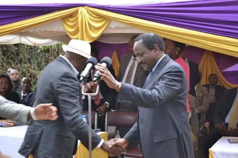 Kalonzo Musyoka interacts with Muthama Nduya at a past event