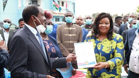 Wiper Kenya Party Leader Kalonzo Musyoka presents Agnes Kavindu with her nomination cetificate.