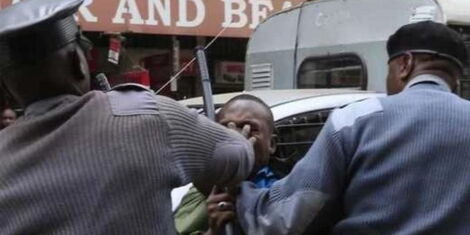 Nairobi County askaris enforcing an arrest at a past event.