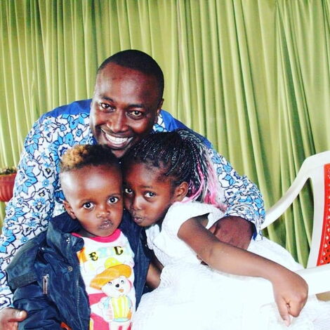 A beaming Pastor Victor Kanyari poses with his children
