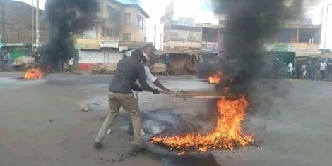 Kenyan residents fight fires started by rowdy youths on Sunday, October 4, 2020.