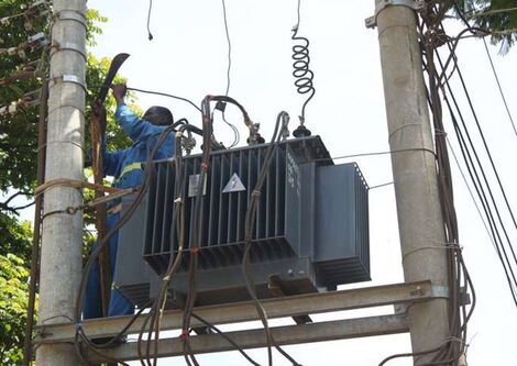 Kenya Power workers repair a transformer on the Meru-Makutano road on March 28, 2016.