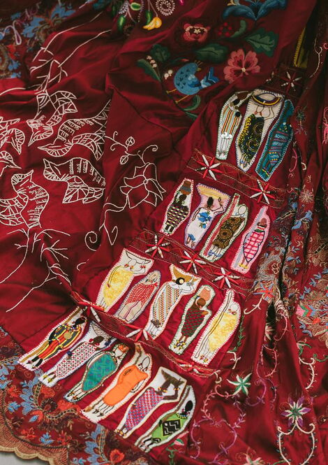Kenyan tradition-inspired embroidery on the red dress