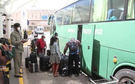 Kenyans board a National Youth Service bus headed to a government quarantine facility on March 24, 2020. 