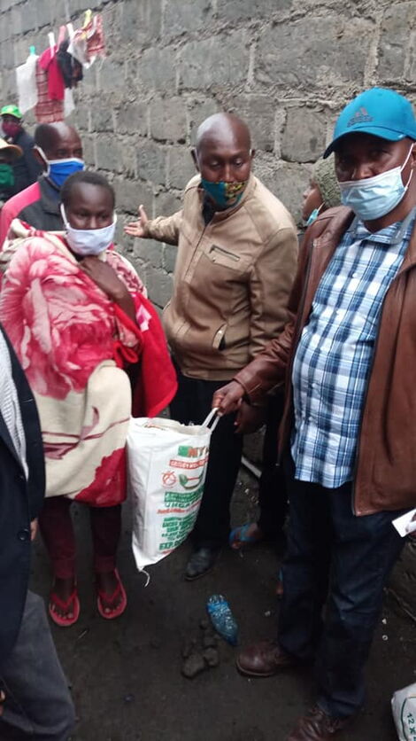 Kimani Ngunjiri poses for a photo with the food donations given to the family on May 5, 2020.