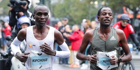 From left to right: Eliud Kipchoge running alongside Guye Adola at the 2017 Berlin Marathon held on September 24.