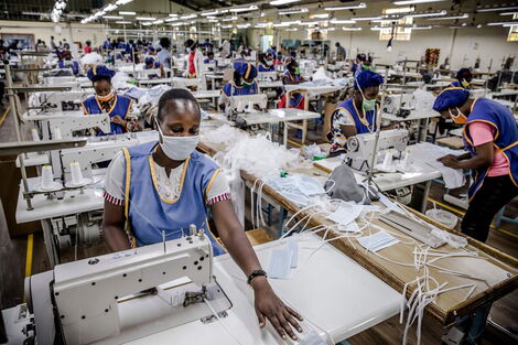 Workers at the Kitui County Textile Centre (KICOTEC) sew surgical masks on Wednesday, April 8, 2020.