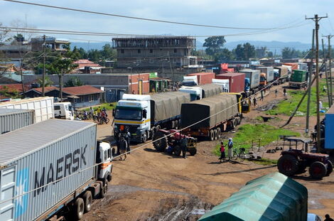 Long distance truck drivers line up before crossing into Uganda.