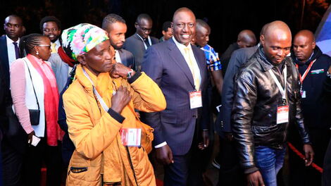 Pauline Waithera accompanied by Deputy President William Ruto after the presidential debate on Tuesday July 26, 2022