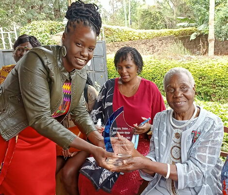 Jael Mbogo (right) receiving an award for her lifelong struggle for freedom, democratization, gender justice and human development for all at her home on October 20
