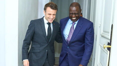 French President Emmanuel Macron (left) and President William Ruto (right) share a light moment during the latter's state visit to France on January 24, 2023.