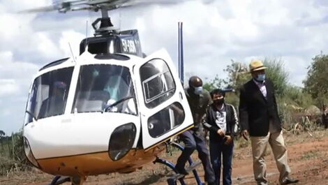 Makueni Governor Kivutha Kibwana stepping out of Deputy William Ruto's helicopter.