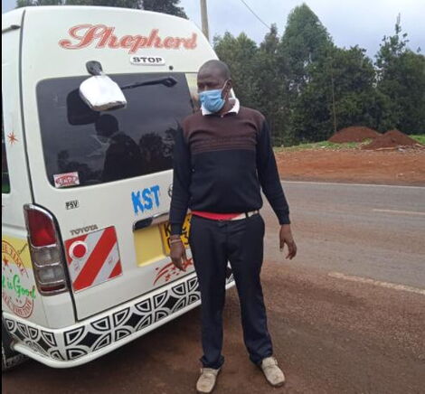 Matatu Driver Basilio Kimani Strikes a Pose Next to his Matatu.