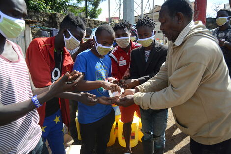 Mathare residents sanitizing their hands in a past event by the Victor Wanyama Foundation, on the 27th March 2020.