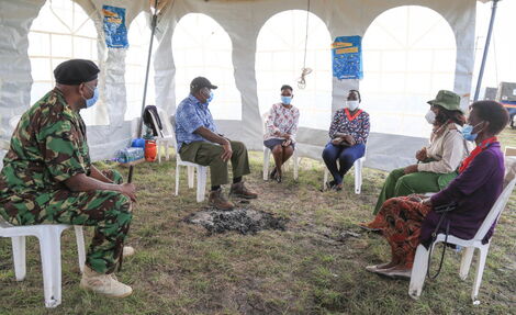 from left: IG Hillary Mutyambai, Interior CS Fred Matiang'i and the three women feeding police officers in Kagundo hold discussions on May 1, 2020.