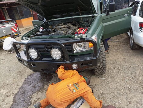 Mechanics work to transform dilapidated Police car at DB Ventures along Thika Road