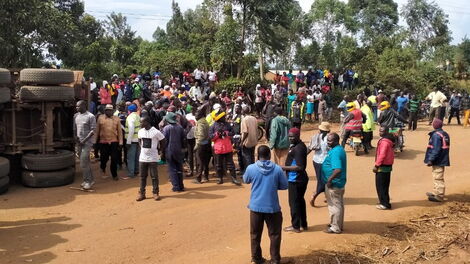 Members of the public at the scene of an accident in Kakamega North, in which a boda-boda rider and his three passengers were crushed to death by a trailer, August 15, 2020.