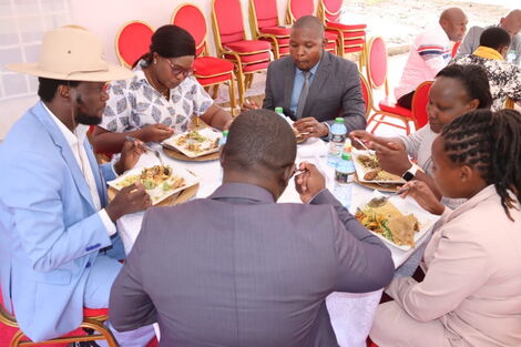 Meru Governor Kawira Mwangaza shares a meal with her spouse and other county officials